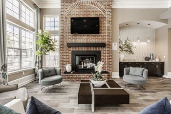 A living room with a fireplace and a television above it.